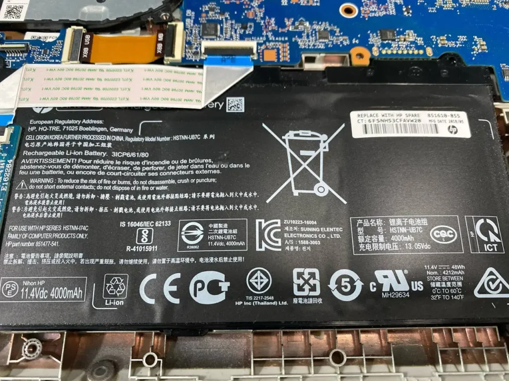 Bloated battery that needs HP laptop battery replacement.