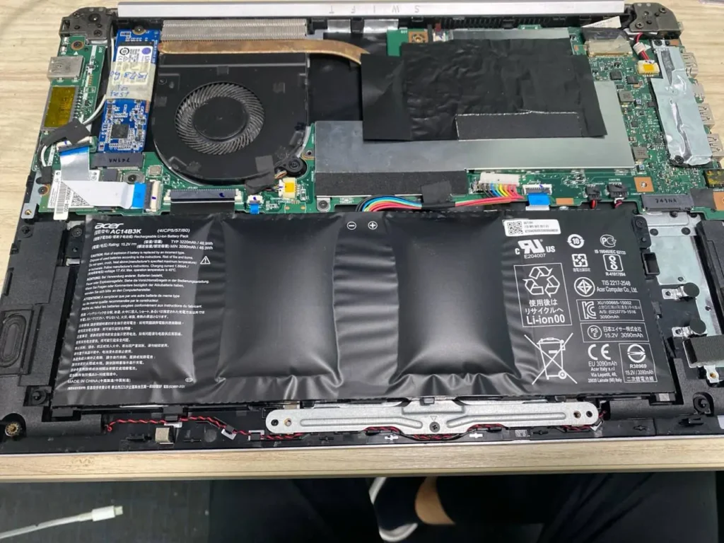 A bloated battery that requires ACER laptop battery replacement.